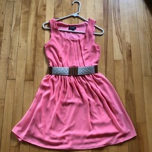 Peach colored dress with light brown leather belt.